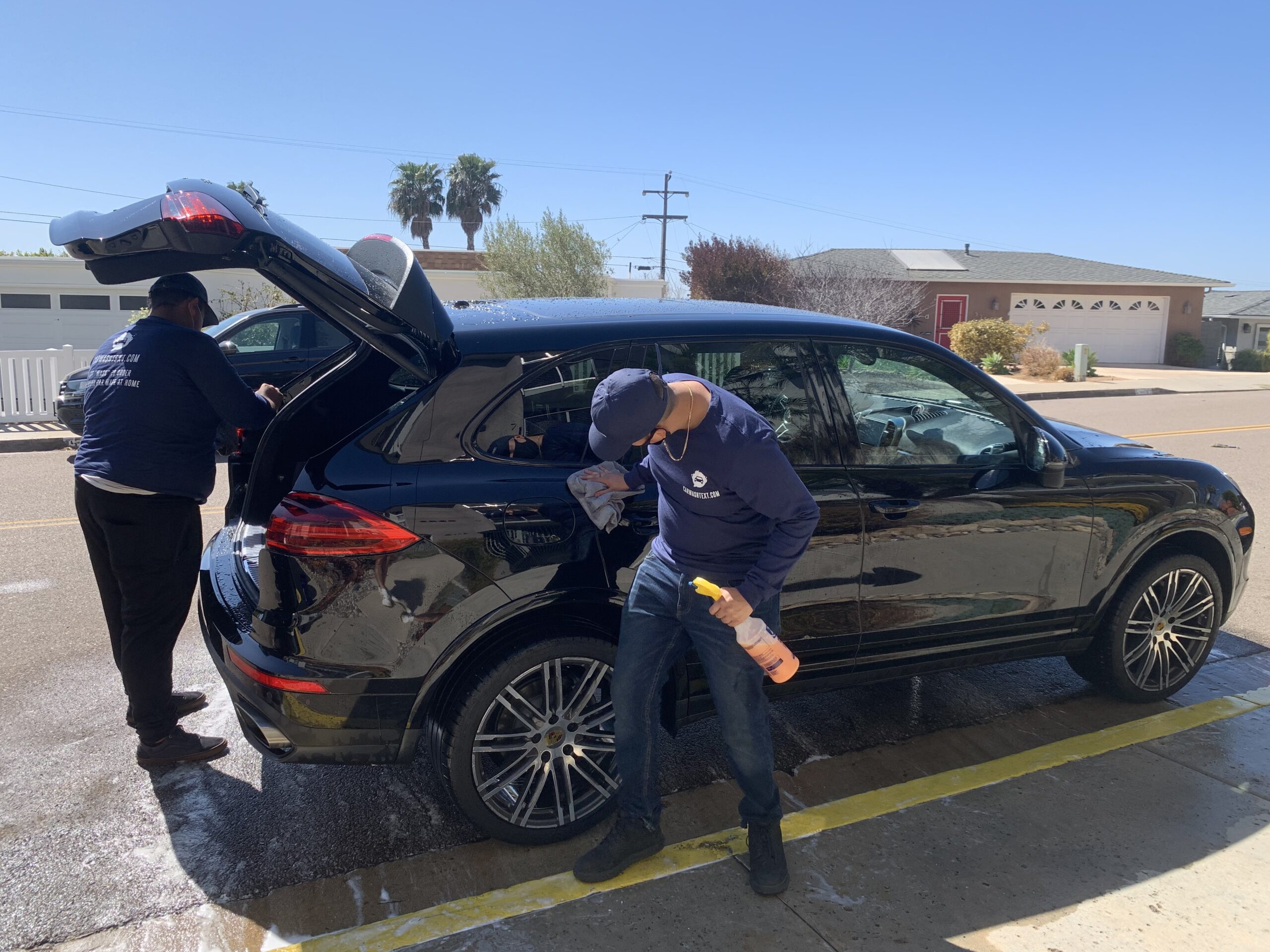 Man washing his car in a garage